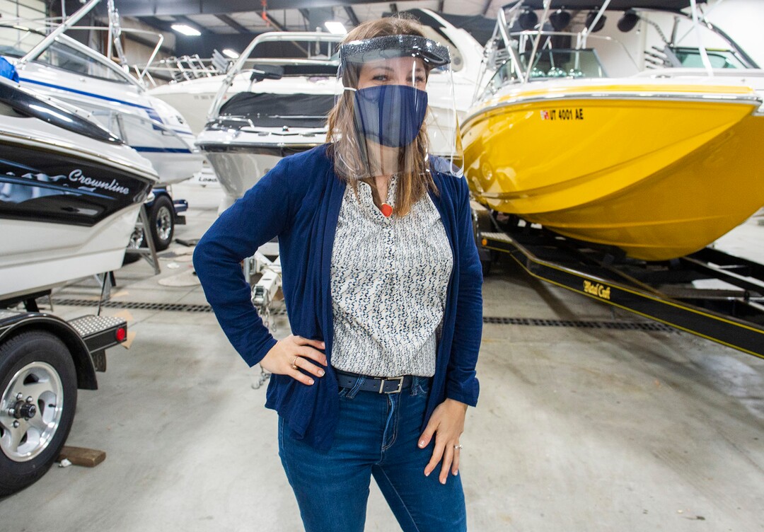 (Rick Egan  |  The Salt Lake Tribune)     Romy Humphries, director of marketing and sales at SugarHouse Industries, demonstrates the make face mask and face shield they are producing out of products they usually use for boat covers, protect against coronavirus, Thursday, March 26, 2020.