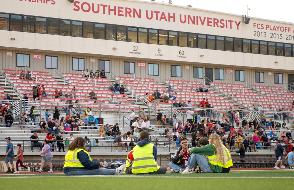 (Cinder Player | Special to the Tribune) Volunteers converse on the field of the Eccles Coliseum before the opening ceremony of the Utah Summer Games in Cedar City, Friday, June 6, 2025.