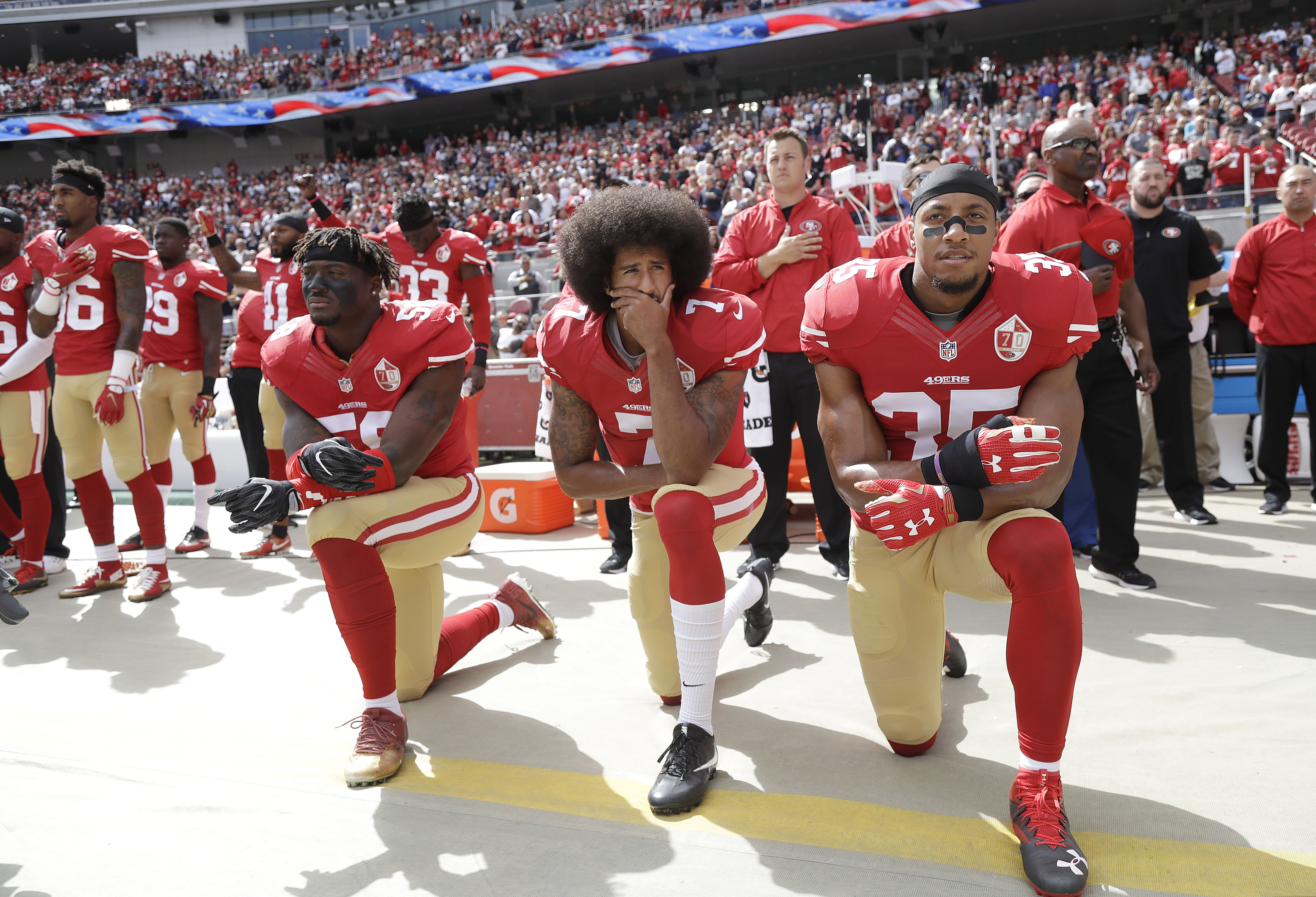 (Jose Sanchez | AP file photo) San Francisco 49ers outside linebacker Eli Harold, left, quarterback Colin Kaepernick, center, and safety Eric Reid kneel during the national anthem before an NFL football game against the Dallas Cowboys in Santa Clara, Calif., on Oct. 2, 2016.