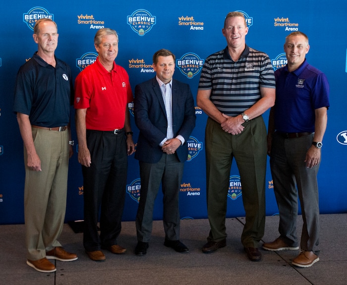 (Rick Egan  |  Tribune File Photo)  Left to Right - Tom Holmoe, Athletic Director, Brigham Young University; Chris Hill, Athletic Director, Steve Starks, President, Larry H. Miller Sports & Entertainment/Utah Jazz; University of Utah; John Hartwell, Athletic Director, Utah State University; Jerry Bovee, Athletic Director, Weber State University gather together for a group photo after announcing the new menÕs college basketball showcase featuring BYU, Utah, USU, and Weber State, at Vivint Smart Home Arena, Thursday, July 21, 2016.