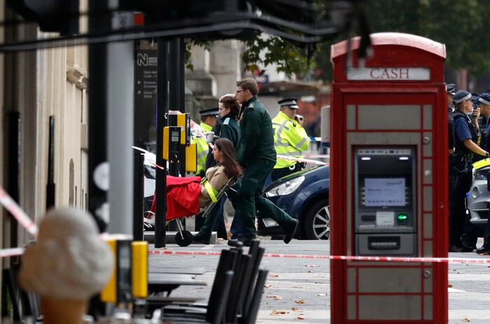 Ambulance personnel push a woman on a stretcher at the scene of an incident in central London, Saturday, Oct. 7, 2017. London police say emergency services are outside the Natural History Museum in London after a car struck pedestrians. (AP Photo/Kirsty Wigglesworth)