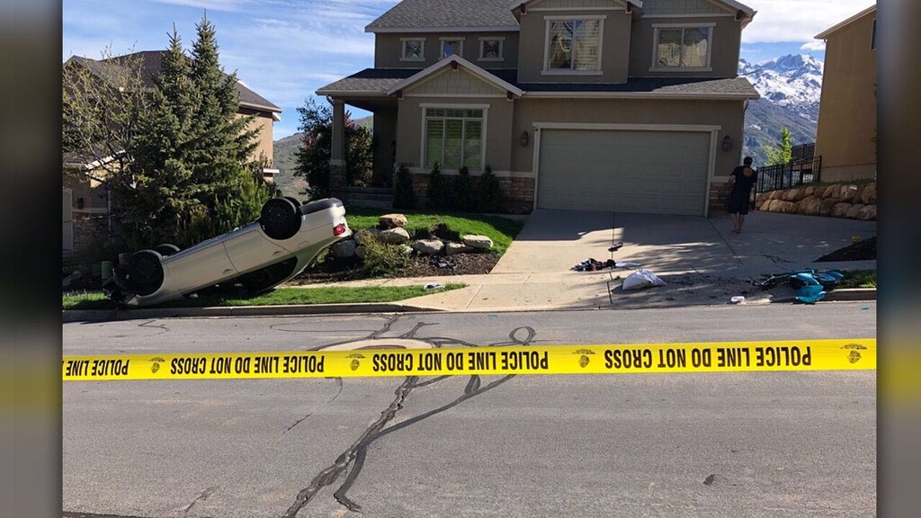 (Photo courtesy FOX 13) An overturned vehicle and pieces of a scooter lay at the scene of a crash Friday, May 31, 2019 in Draper. Police believe the car's driver, 19-year-old Steven Becky, intentionally struck an 11-year-old girl who was pushing an electric scooter. Becky was arrested on allegations of attempted homicide and DUI.