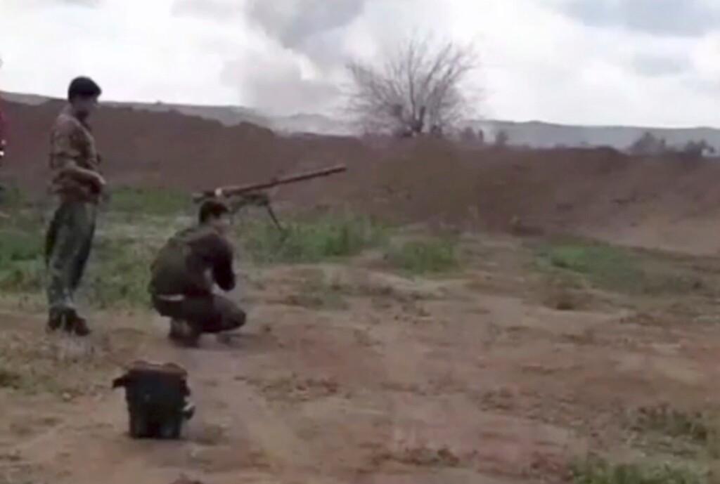 (Syrian Observatory for Human Rights via AP)  This frame grab from video provided on Tuesday, Feb. 12, 2019, by the Syrian Observatory for Human Rights, an opposition group, that is consistent with independent AP reporting, shows U.S.-backed Syrian Democratic Forces fighters take their position during a battle against Islamic State group militants, in the village of Baghouz, Deir El-Zour, eastern Syria. Fighting between U.S.-backed fighters and IS inflicted more casualties among people fleeing the violence in eastern Syria Tuesday where the extremists are on the verge of losing the last area they control.