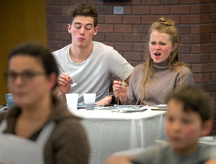 (Leah Hogsten  |  The Salt Lake Tribune) Students Grant Keller, from left, and Kirsten McDonough became frustrated with the speed and effortlessness that former television star painter Bob Ross showed as they tried to follow along with the video during a Bob Ross Paint-Along class, Saturday, Jan. 6, 2018, at the Salt Lake City Public Library's Sweet Branch in the Avenues.