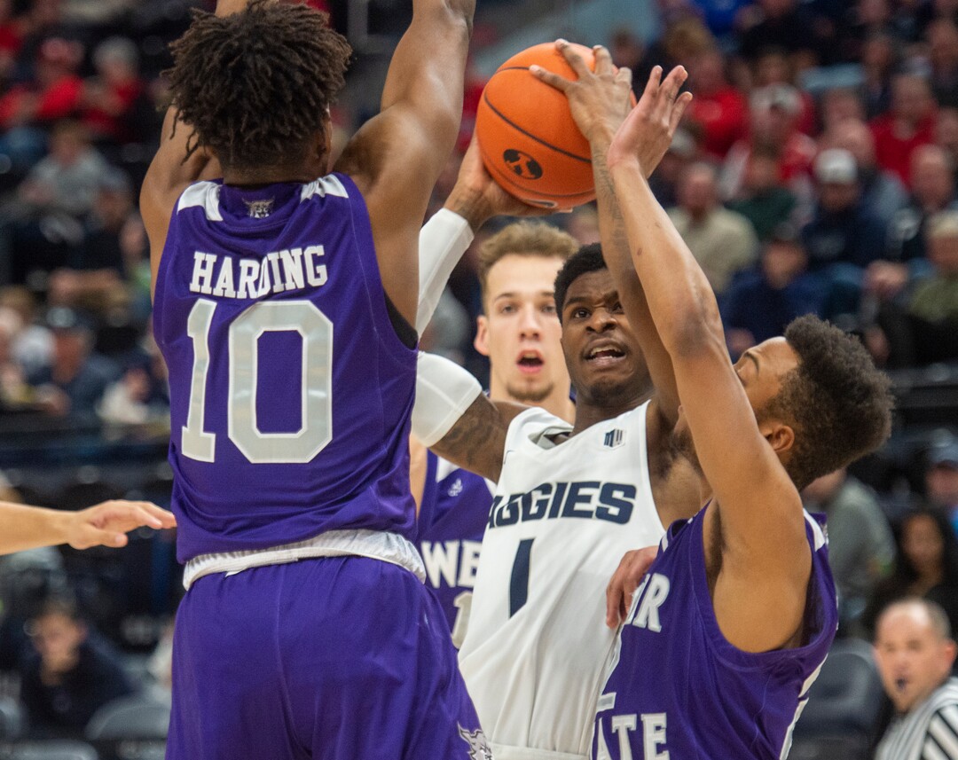 (Rick Egan  |  The Salt Lake Tribune)   Utah State Aggies guard Tauriawn Knight (1) looks for a shot,i traffic, as Weber State Wildcats guard Jerrick Harding (10) defends, in the Beehive Classic, between against the Utah State Aggies and Weber State Wildcats, a the Vivint Smart Home Arena, Saturday December 8, 2018. 