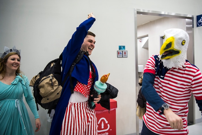 (Chris Detrick  |  The Salt Lake Tribune)  Adam Harpham, stationed at U.S. Army Garrison Yongsan gives a high-five a man dressed as a bald eagle while his wife Amanda Harpham watches during the United States vs Olympic Athletes from Russia hockey game at Gangneung Hockey Centre during the Pyeongchang 2018 Winter Olympics Saturday, Feb. 17, 2018. Olympic Athletes from Russia defeated United States 4-0.