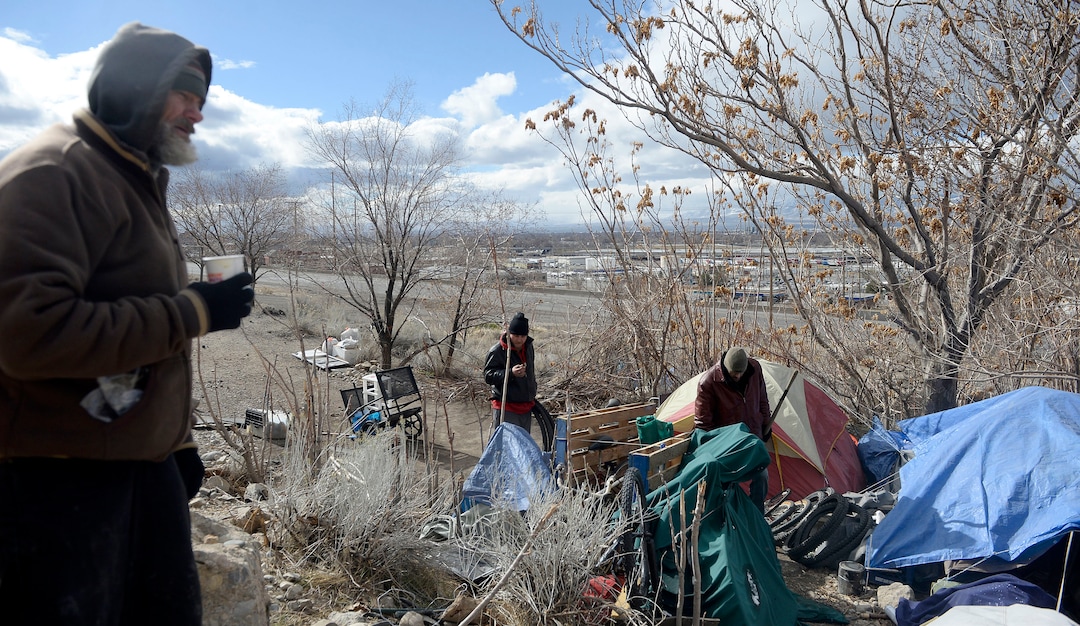 (Al Hartmann  |  The Salt Lake Tribune) 	
Several homeless men with their belongings camp on the mountainside above Victory Road north of the state Capitol building.  Salt Lake City Police, Volunteers of America, Utah Highway Patrol, and social workers from Salt Lake City and the Veterans Administration had set up an mobile outreach center along Victory Road.