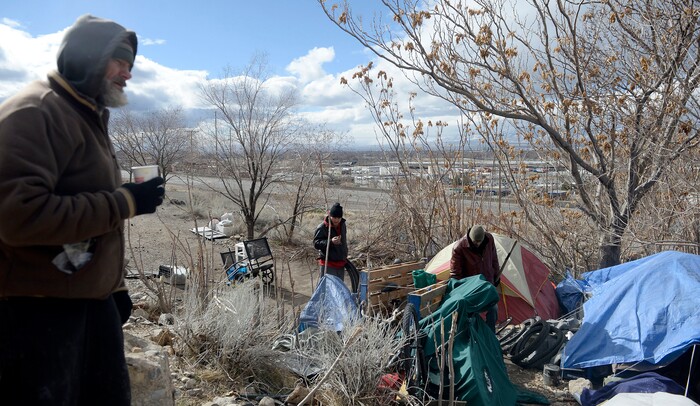 (Al Hartmann  |  The Salt Lake Tribune) 	
Several homeless men with their belongings camp on the mountainside above Victory Road north of the state Capitol building.  Salt Lake City Police, Volunteers of America, Utah Highway Patrol, and social workers from Salt Lake City and the Veterans Administration had set up an mobile outreach center along Victory Road.
