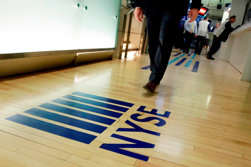 (Richard Drew | The Associated Press) In this April 5, 2018, file photo, an NYSE logo adorns the entrance to the trading floor the New York Stock Exchange. Never has it been so cheap to put money into the market, and it’s about to get even cheaper following Vanguard’s recent decision to end online commissions for most ETFs.