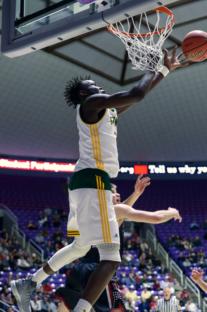 (Leah Hogsten  |  The Salt Lake Tribune) Kearns' Emmanuel Andrew (04) with the dunk. Andrew had 10 points and 17 rebounds. Weber defeated Kearns 60-52 in the 6A High School Boys' Basketball Tournament opening game at Weber State University’s Dee Events Center in Ogden, Tuesday, Feb. 27, 2018. 