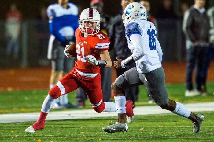 (Chris Detrick  |  The Salt Lake Tribune)  East's Charlie Vincent (21) runs past IMG Academy's Shamaur Mcdowell (16) during the game at East High School Friday, October 20, 2017. 