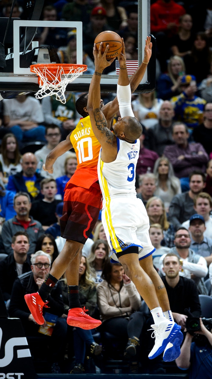 (Steve Griffin  |  The Salt Lake Tribune) Golden State Warriors forward David West (3) tries to dunk over Utah Jazz guard Alec Burks (10) during the Utah Jazz versus Golden State Warriors at Vivint Smart Home Arena in Salt Lake City Tuesday January 30, 2018.