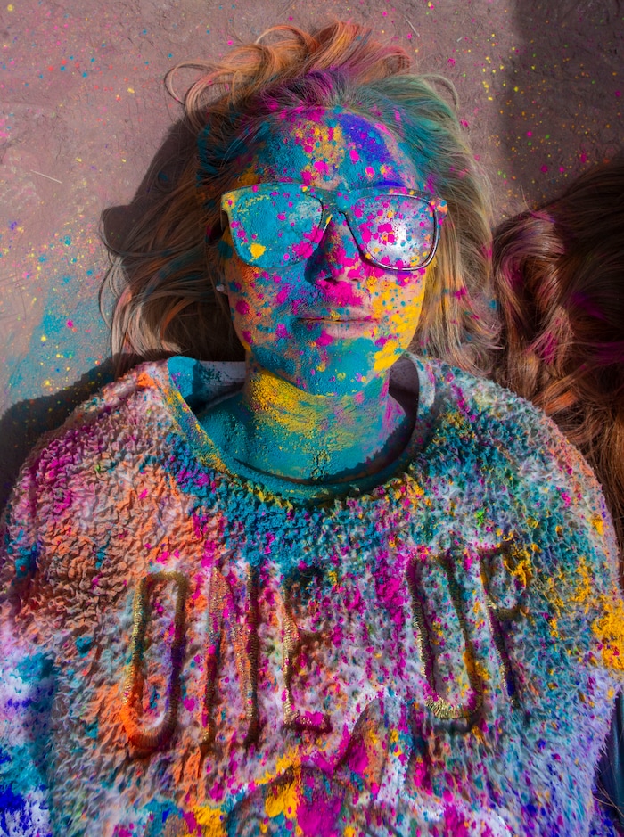 (Rick Egan  |  The Salt Lake Tribune)    
Kimberly Woolsey, from Gilbert , Arizona, takes a break from the crowd and lies not the ground, during the Holi Festival of Colors celebration at the Sri Sri Radha Krishna Temple in Spanish Fork, Saturday, March 30, 2019.
 