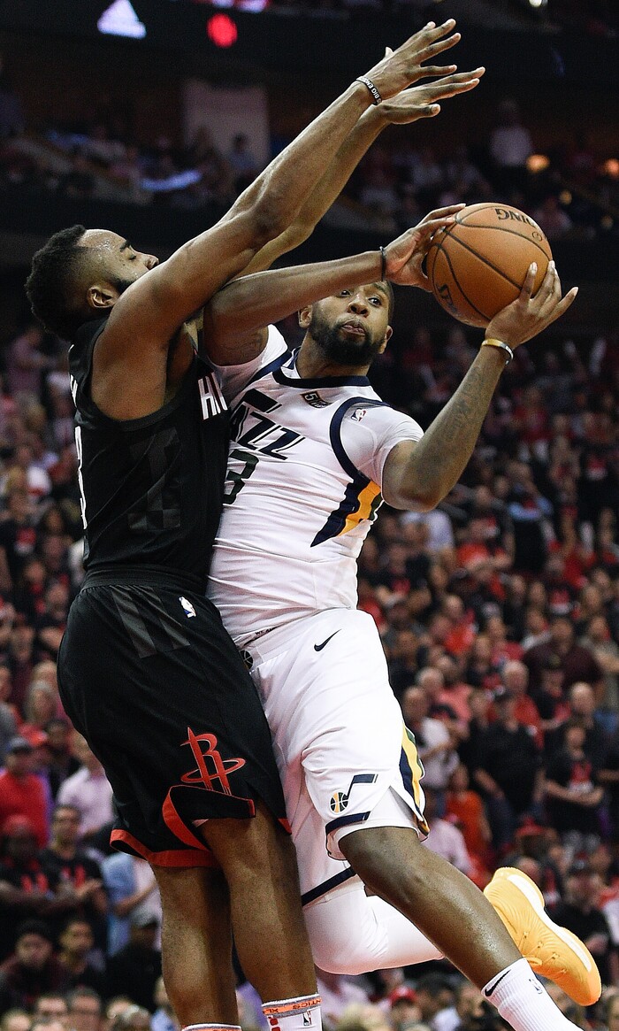 Utah Jazz forward Royce O'Neale, right, looks to pass as Houston Rockets guard James Harden defends during the second half in Game 5 of an NBA basketball second-round playoff series, Tuesday, May 8, 2018, in Houston. (AP Photo/Eric Christian Smith)