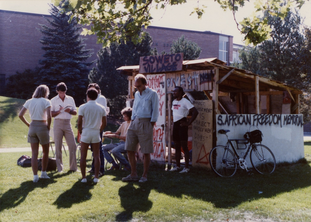 (Special Collections, Marriott Library, University of Utah) University of Utah students erect a structure to advocate the university’s divestment of South Africa in 1985. The group, Students Against Apartheid, joined protests around the world to end segregation.