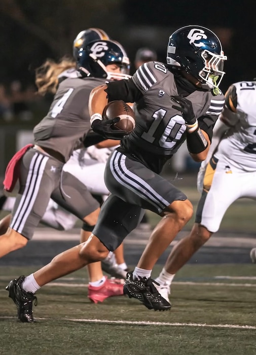 Utah 3-star commit and Corner Canyon ATH Diesel Dart (No. 10) running with the football against an opponent.