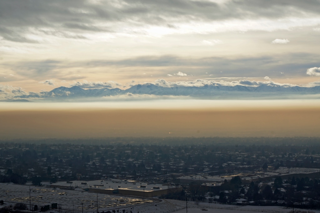 (Sebastian Hock | The University of Utah) A winter temperature inversion traps smog over the Salt Lake Valley. A new University of Utah study found that as much as 13 percent of the water vapor in the smog comes from fossil-fuel combustion. The combustion vapor not only rises and falls in concert with daily traffic rush hours and overnight use of home furnaces, but also correlates with rises and falls in combustion-produced carbon dioxide, the major gas causing global warming. Measuring chemical signatures in water vapor from combustion may provide researchers a new way to trace the sources of pollutants and carbon dioxide.