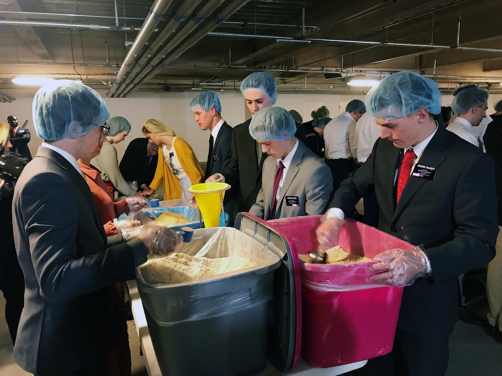 (Benjamin Wood  |  The Salt Lake Tribune)  Missionaries Scott Hulbert, right, and Nolan Haggen, left, prepare meal kits during a service project at the Provo Missionary Training Center on Thursday, Nov. 22, 2018.