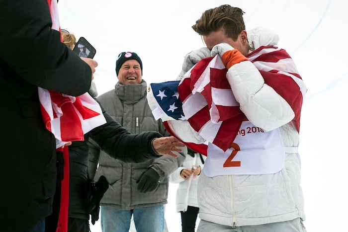 (Chris Detrick  |  The Salt Lake Tribune)  Shaun White reacts to seeing his friends and family after winning gold after his run during the men's halfpipe finals at Phoenix Snow Park during the Pyeongchang 2018 Winter Olympics Wednesday, Feb. 14, 2018.  White won the event with a 97.75, his third Olympic gold medal in the halfpipe (2006, 2010, 2018).