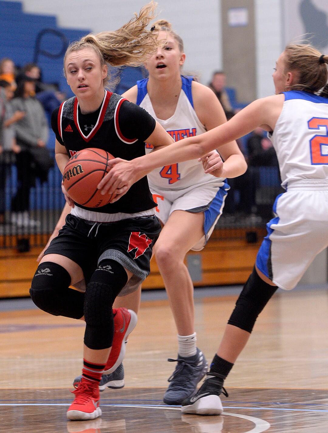 (Al Hartmann  |  The Salt Lake Tribune) 	West High School's Whitney Banz casts a side glance at Timpview's Ella Pope and Madelyn Boulton in the Class 5 girls' basketball playoff game Monday Feb. 19 2018