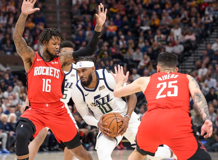(Leah Hogsten  |  The Salt Lake Tribune)  Utah Jazz guard Mike Conley (10) slips past the defense of Houston Rockets guard Ben McLemore (16) and Houston Rockets guard Austin Rivers (25). The Utah Jazz host the Houston Rockets at Vivint Arena, Feb. 22, 2020.