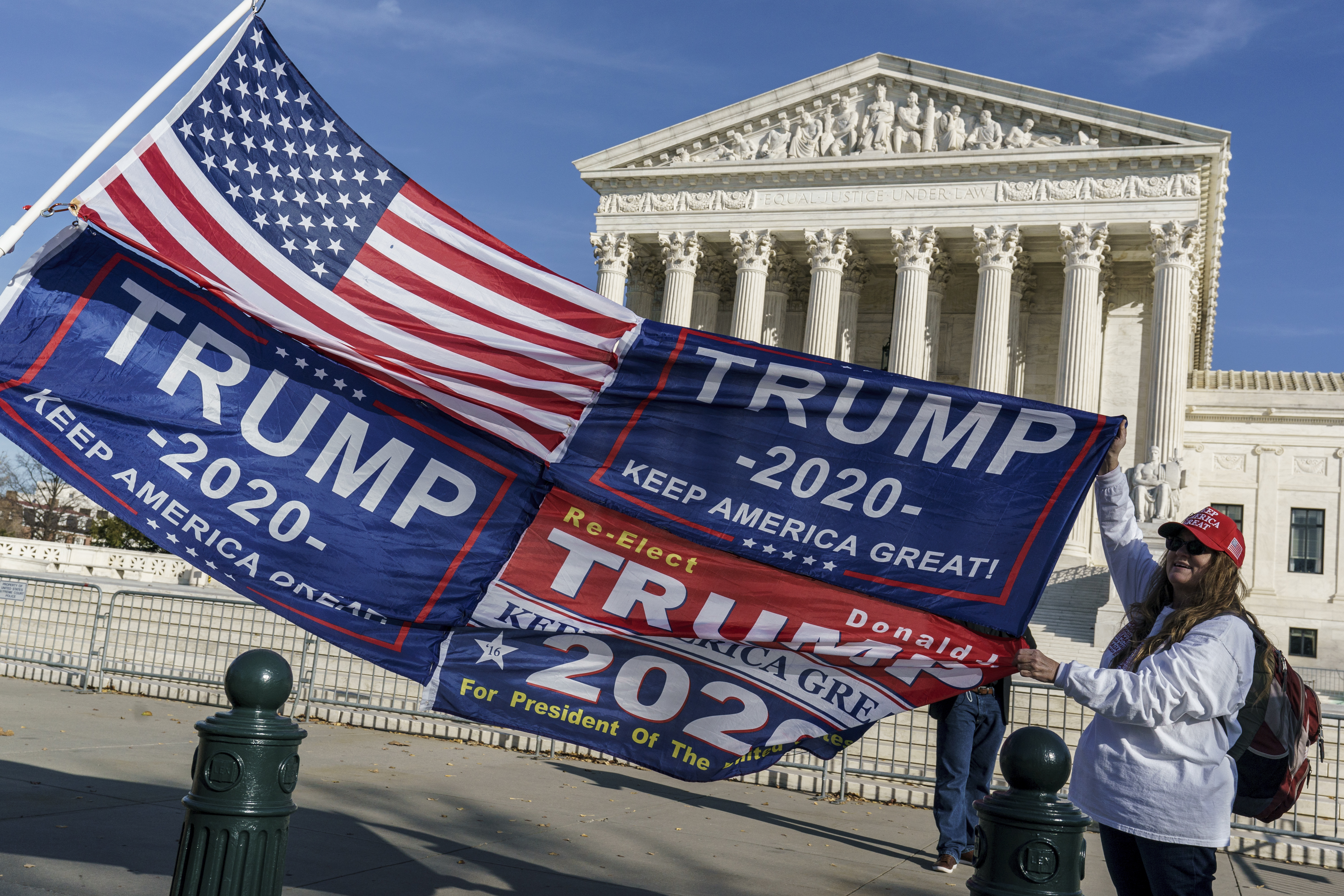 (J. Scott Applewhite | AP file photo)  Kathy Kratt of Orlando, Fla., displays her Trump flags as she and other protesters demonstrate their support for President Donald Trump at the Supreme Court in Washington, Friday, Dec. 11, 2020.