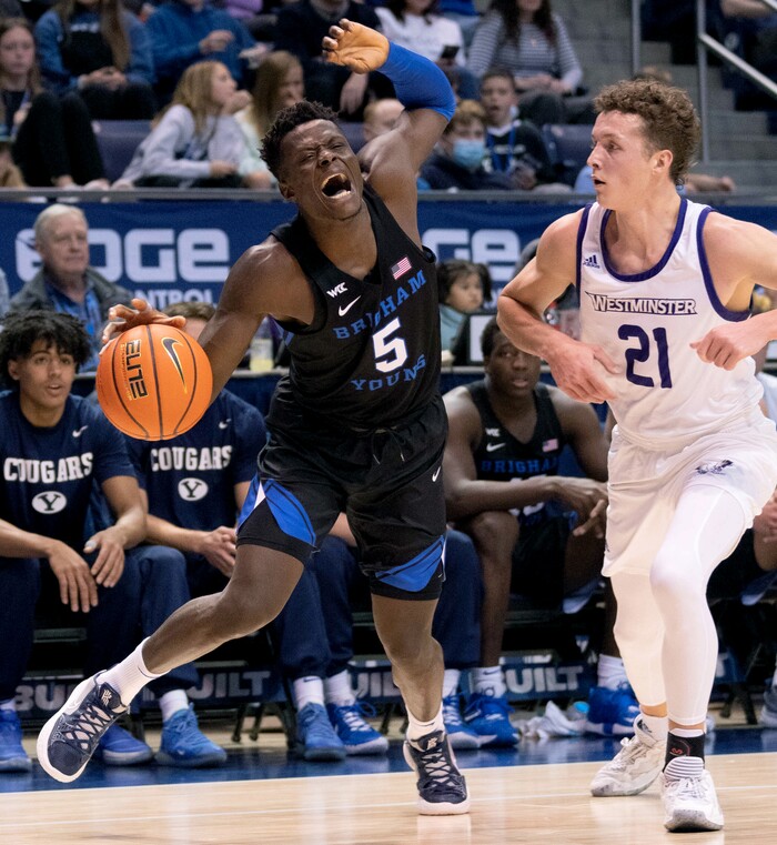 (Francisco Kjolseth | The Salt Lake Tribune) Brigham Young Cougars forward Gideon George (5) if founded by Westminster Griffins forward Lewis Johnson (21) in basketball action between the Brigham Young Cougars and the Westminster Griffins at the Marriott Center in Provo, Wednesday, Dec. 29, 2021.
