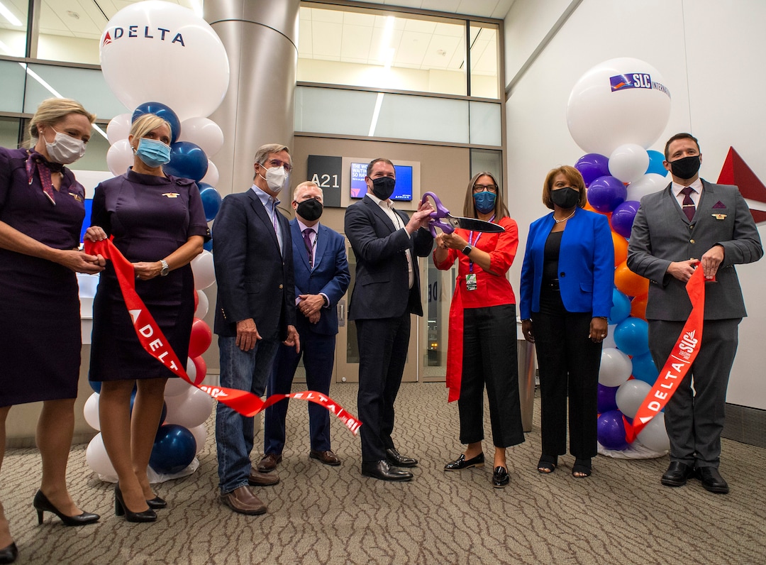 (Rick Egan | The Salt Lake Tribune) Eric Phillips, center left, senior vice president of airport customer service and cargo for Delta Air Lines, and Salt Lake City Mayor Erin Mendenhall, center right, cut the ribbon at the opening of at the new terminal at the Salt Lake City International Airport on Tuesday, Sept. 15, 2020.