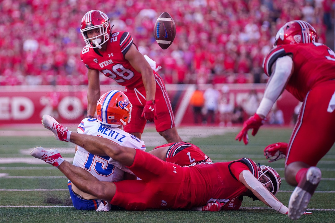 (Trent Nelson  |  The Salt Lake Tribune) Florida Gators quarterback Graham Mertz (15) loses the ball after a hit from Utah Utes safety Cole Bishop (8) as the Utah Utes host the Florida Gators, NCAA football in Salt Lake City on Thursday, Aug. 31, 2023.