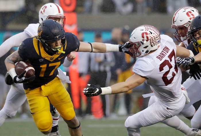 California wide receiver Vic Wharton III (17) stiff arms Stanford linebacker Sean Barton (27) on a punt return during the first half of an NCAA college football game Saturday, Nov. 19, 2016, in Berkeley, Calif. (AP Photo/Marcio Jose Sanchez)