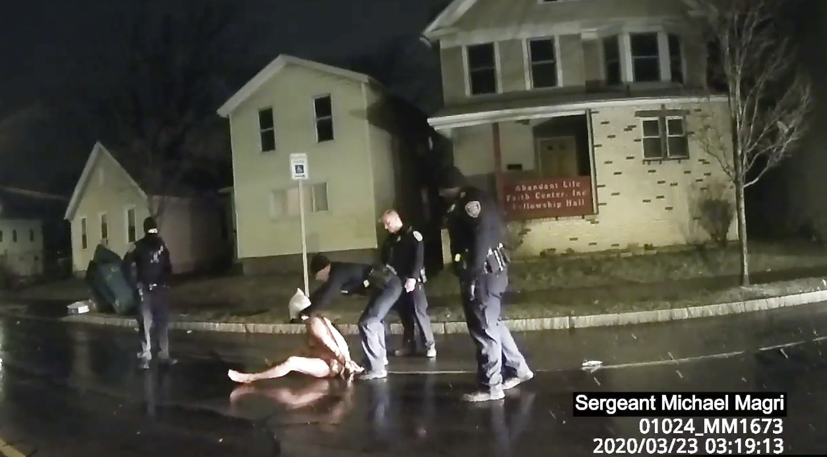 (Rochester Police via Roth and Roth LLP via AP) In this image taken from police body camera video provided by Roth and Roth LLP, a Rochester police officer puts a hood over the head of Daniel Prude, on March 23, 2020, in Rochester, N.Y. Video of Prude, a Black man who had run naked through the streets of the western New York city, died of asphyxiation after a group of police officers put a hood over his head, then pressed his face into the pavement for two minutes, according to video and records released Wednesday, Sept. 2, 2020, by his family. Prude died March 30 after he was taken off life support, seven days after the encounter with police in Rochester.