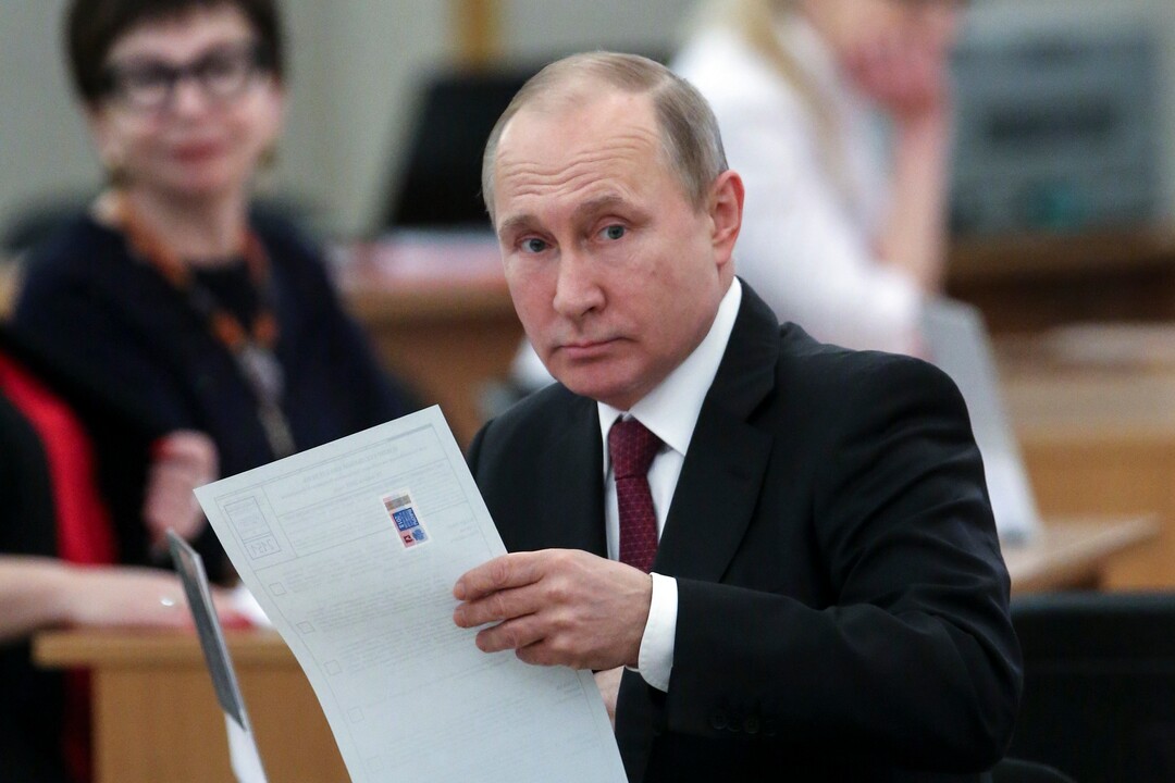 Russian President and Presidential candidate Vladimir Putin prepares to cast his ballot during Russia's presidential election in Moscow, Russia, Sunday, March 18, 2018. Putin's victory in Russia's presidential election Sunday isn't in doubt. The only real question is whether voters will turn out in big enough numbers to hand him a convincing mandate for his fourth term ó and many Russian workers are facing intense pressure to do so. (Sergei Chrikov/Pool Photo via AP)