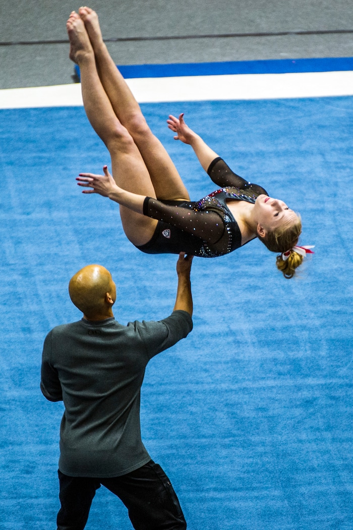Chris Detrick  |  The Salt Lake TribuneCo-Head Coach Tom Farden helps Utah gymnast Shannon McNatt performs her floor routine during the Red Rocks Preview at the Huntsman Center Friday December 11, 2015.  