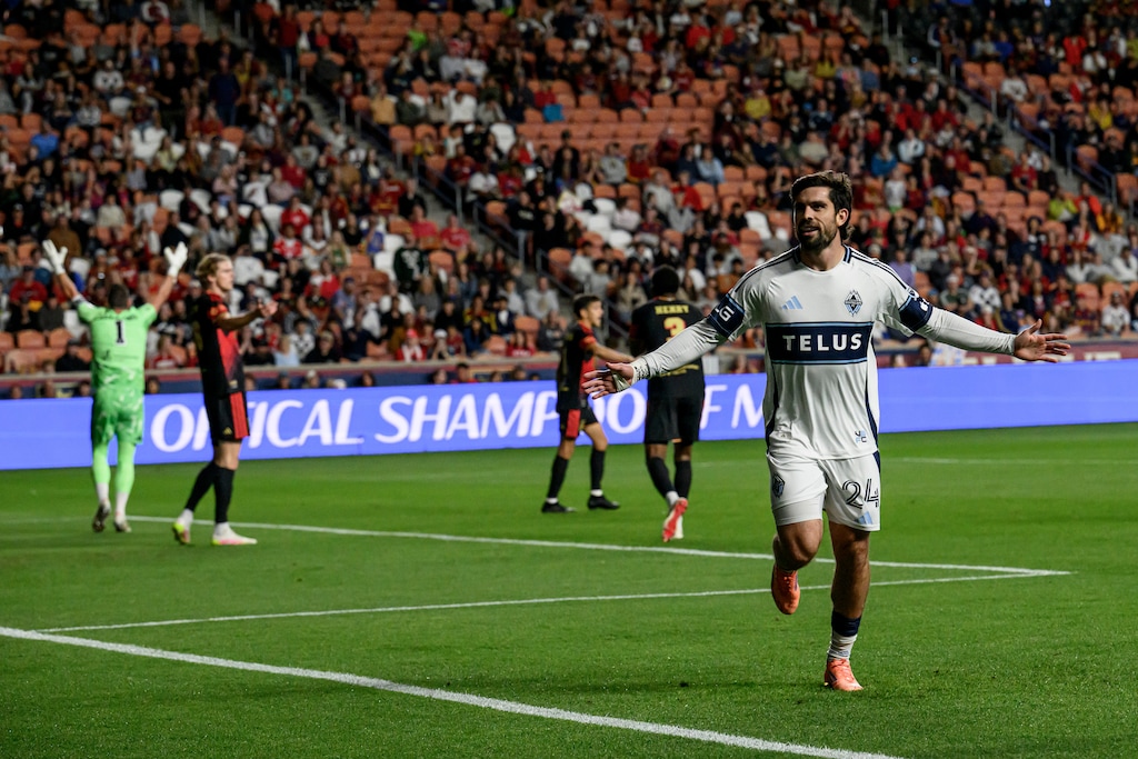 Vancouver Whitecaps forward Brian White (24) celebrates after scoring the first goal of an MLS soccer match against the Real Salt Lake, Saturday, Sept. 19, 2026, in Sandy, Utah. At left, RSL goalkeeper Rafael Cabral unsuccessfully calls for an offside ruling.(AP Photo/Tyler Tate)