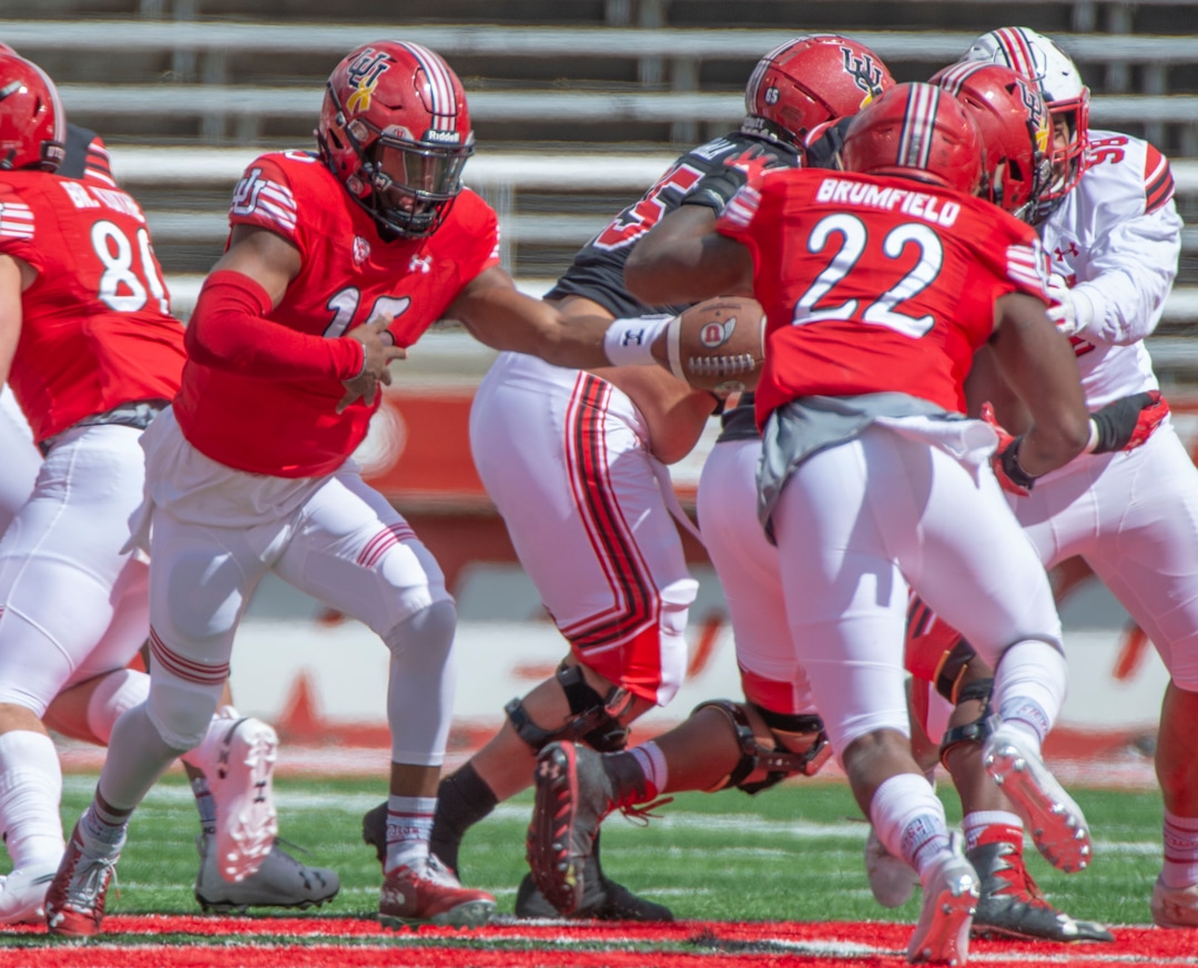 (Rick Egan  |  The Salt Lake Tribune)  Quarterback Jasom Shelley hands off the ball to Devin Brufield, in Utah's spring Red-White game at Rice-Eccles Stadium, Saturday, April 13, 2019.