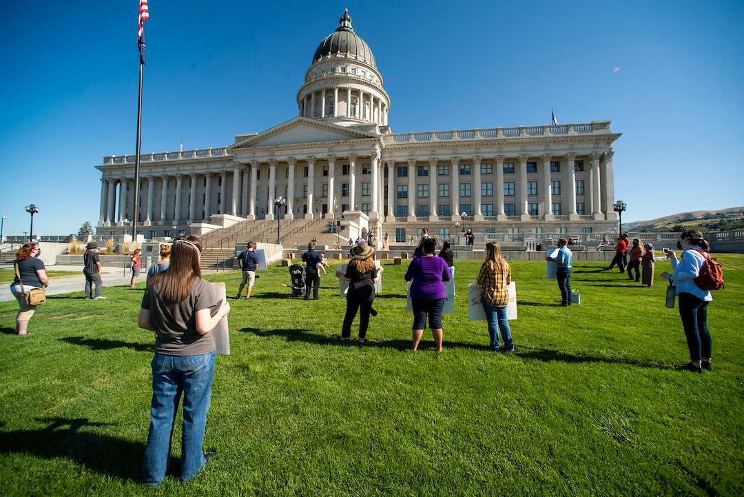 (Rick Egan  |  The Salt Lake Tribune)     Protesters social-distance on the lawn as they listen to speakers, during a Mask-In and Car Caravan protest at the State Capitol to demand the governor and other state local leaders ensure Utah school protect students and staff when schools reopen. Thursday, July 23, 2020.