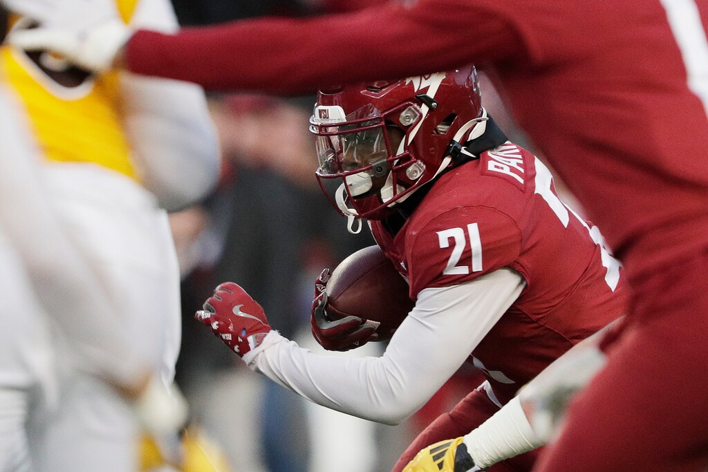 (Young Kwak |AP) Former Washington State running back Wayshawn Parker (21) carries the ball during a game on Nov. 30, 2024, in Pullman, Wash. Parker could be the University of Utah's top rushing option this season after transferring to Salt Lake City.