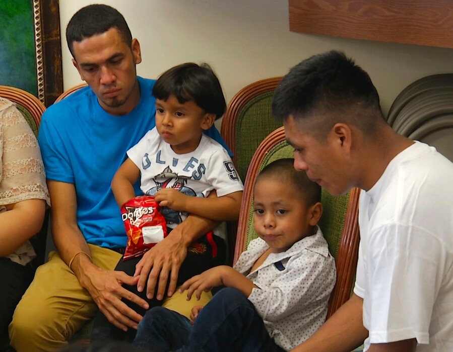 In this image taken from video, Javier Garrido Martinez, left and Alan Garcia, right, sit with their 4-year-sons at a news conference in New York, Wednesday, July 11, 2018. They men were reunited with their children after almost two months of separation, Authorities took their boys them when they stopped at the U.S. southern border. (AP Photo/Robert Bumsted)