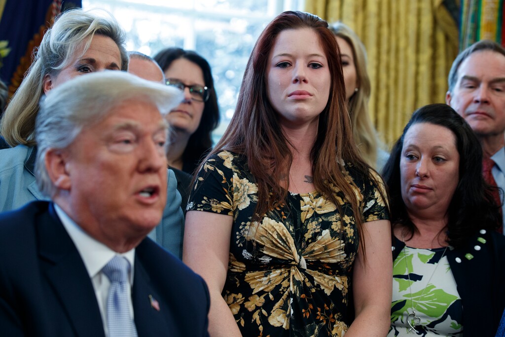 Victims of human trafficking, family members, and lawmakers listen as President Donald Trump speaks in the Oval Office at the White House before signing a new law aimed at curbing six trafficking Wednesday, April 11, 2018, in Washington. (AP Photo/Evan Vucci)
