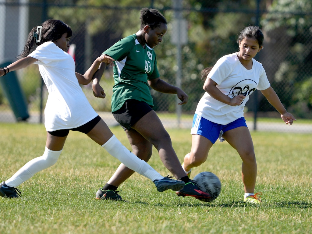 (Leah Hogsten | The Salt Lake Tribune) #SheBelongs soccer players, from left, Annie Arumagarasa and Romisha Adhikari pressure their opponent during a scrimmage with Olympus High School soccer team, July 5, 2023. #SheBelongs is a team of female soccer players, ages 16 to 18, consisting of equal players from refugee backgrounds and local, non-refugee, local communities with the goal of fostering gender equality empowerment, belonging, fellowship and the advancement of women.