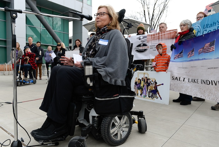 (Francisco Kjolseth  |  The Salt Lake Tribune)  Bonnie Mitchell who has Ehlers Danlos Syndrome, an inherited connective tissue disease lends her voice to speak out over the current tax plan being discussed that eliminates the deception for medical expenses and long term care. A group of Utahns gathered to rally at the Wallace Bennett Federal Building in Salt Lake on Monday, Nov. 20, 2017, to tell personal stories of how they might be impacted by the tax reform plans currently on the table in Congress.