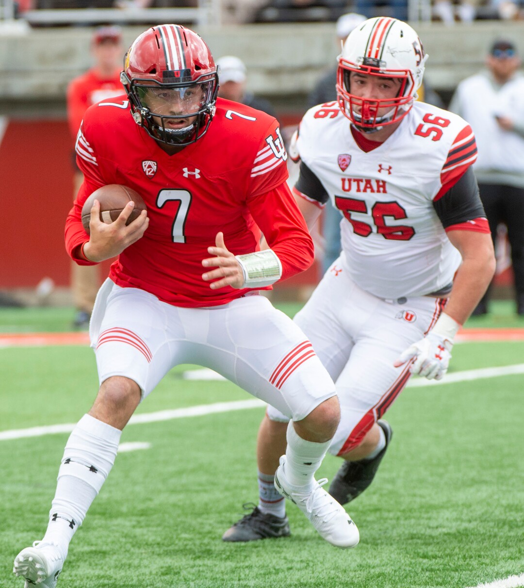 (Rick Egan  |  The Salt Lake Tribune)  Quarterback Cameron Rising (7) runs the ball, as Defense end, Tyler Gonzalez (56) defends, in Utah's spring Red-White game at Rice-Eccles Stadium, Saturday, April 13, 2019.