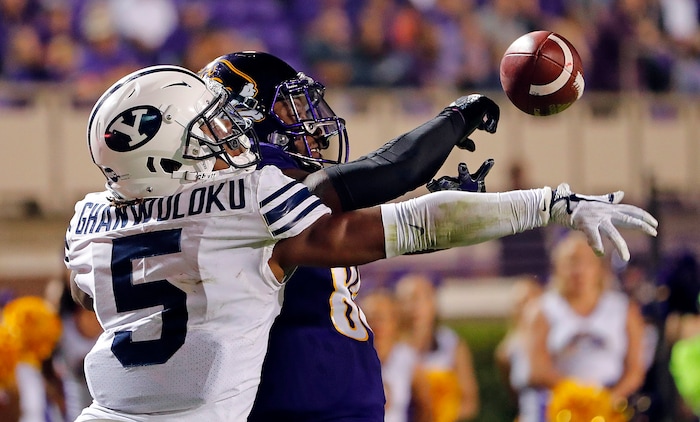BYU's Dayan Ghanwoloku (5) knocks the ball way from East Carolina's Trevon Brown (88) during the second half of an NCAA college football game in Greenville, N.C., Saturday, Oct. 21, 2017. (AP Photo/Karl B DeBlaker)