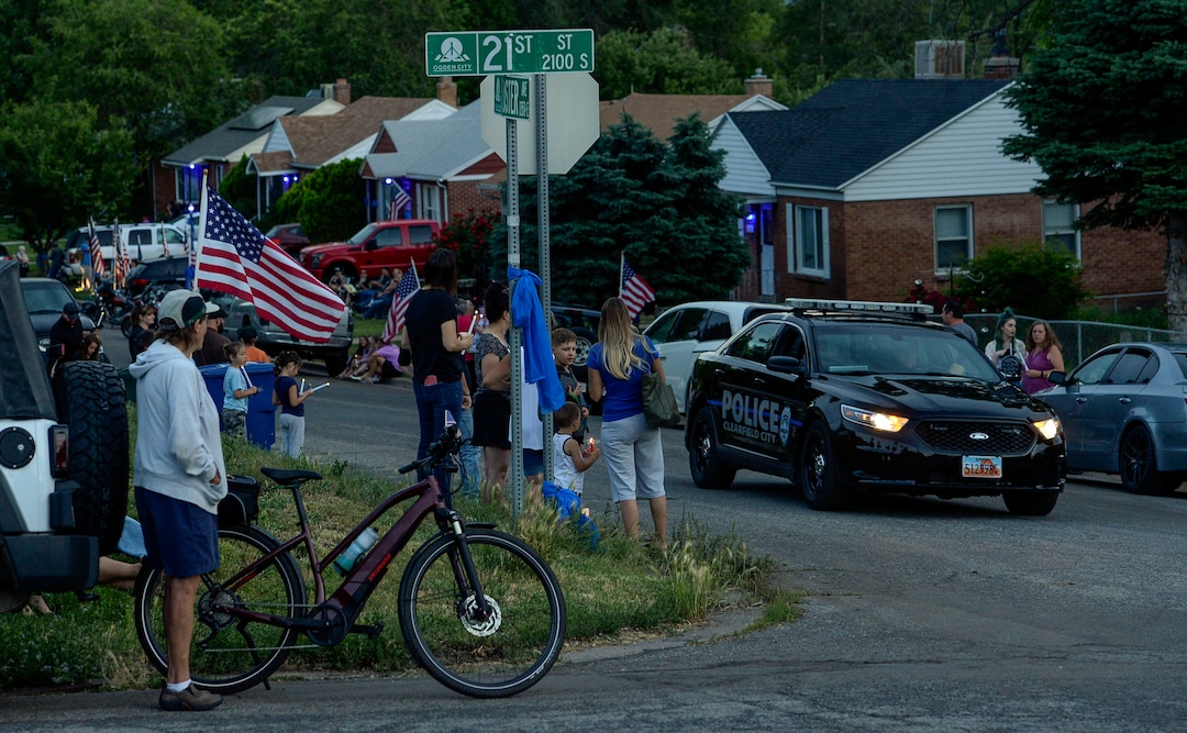 (Leah Hogsten  |  The Salt Lake Tribune) Friends and supporters lined the neighborhood of Officer Nate Lyday's childhood home on Custer Avenue in Ogden prior to the Memorial Procession and Community Vigil in honor of Lyday's life. The procession made its way through five other Ogden landmarks before ending at Lindquist Field.