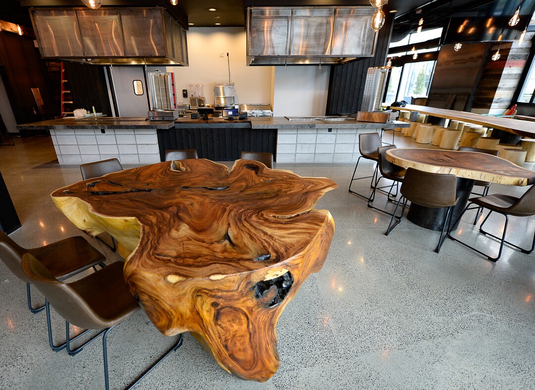 (Francisco Kjolseth  |  The Salt Lake Tribune)  Tables made from acacia wood, and murals by artist Donovan Fitzgerald, inside the new food hall at The Gateway.