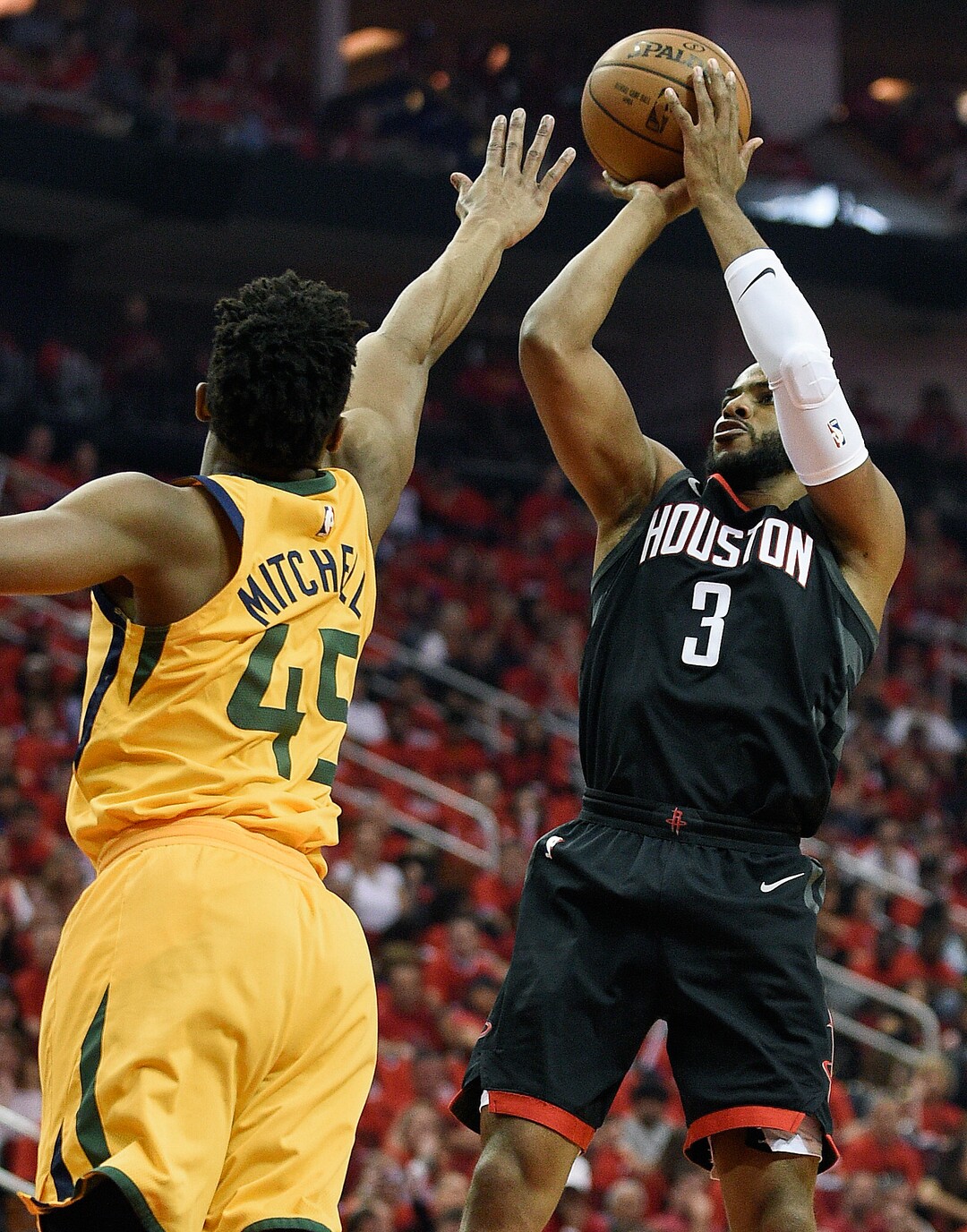Houston Rockets guard Chris Paul (3) shoots over Utah Jazz guard Donovan Mitchell during the first half in Game 1 of an NBA basketball second-round playoff series, Sunday, April 29, 2018, in Houston. (AP Photo/Eric Christian Smith)