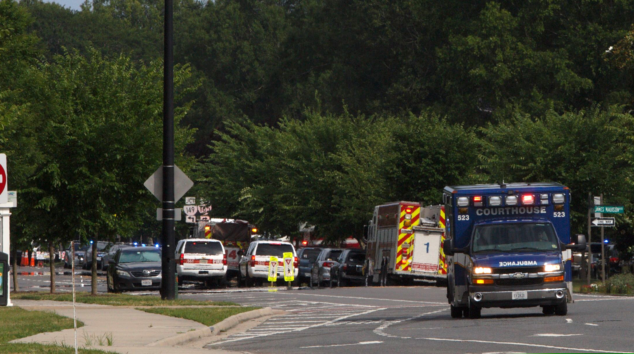 (Kaitlin McKeown/The Virginian-Pilot via AP) Emergency vehicle are seen near the intersection of Princess Anne Road and Nimmo Parkway following a shooting at the Virginia Beach Municipal Center on Friday, May 31, 2019 in Virginia Beach, Va. At least one shooter wounded multiple people at a municipal center in Virginia Beach on Friday, according to police, who said a suspect has been taken into custody.