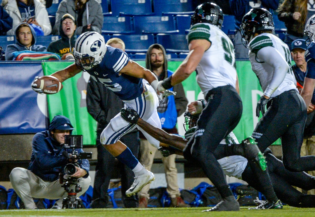 Leah Hogsten  |  The Salt Lake Tribune Brigham Young Cougars wide receiver Aleva Hifo (15) dives into the end zone for a touchdown as Brigham Young University hosts Hawaii at Lavell Edwards Stadium in Provo, Saturday Oct. 13, 2018. BYU defeated Hawaii 49-23.