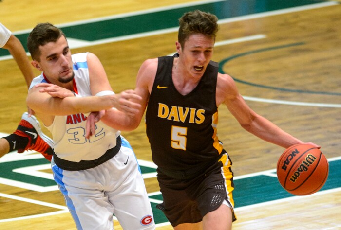 (Steve Griffin  |  The Salt Lake Tribune) Davis guard Josh Sanders drives up court as Granger's Anel Alagic presses him during the Granger versus Davis 6A basketball playoff game at Utah Valley UniversityÕs UCCU Center in Provo Tuesday Feb. 27, 2018.