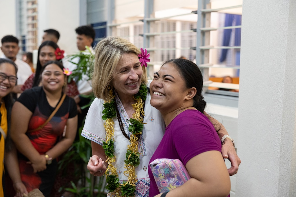(The Church of Jesus Christ of Latter-day Saints) Relief Society General President Camille Johnson embraces a young woman after a devotional for young single adults in Apia, Samoa.